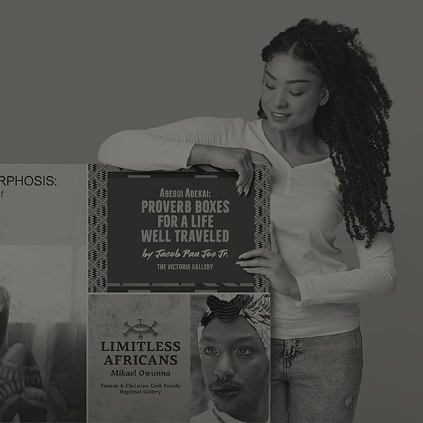 Woman showing a poster from August Wilson Cultural Center.